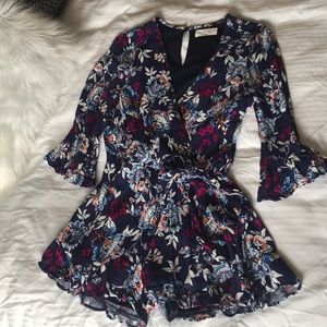 Floral romper with ruffle sleeves and shorts.